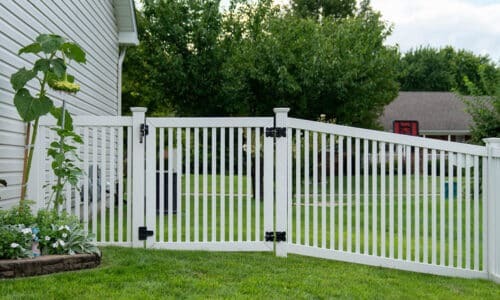White fence with gate on hillside