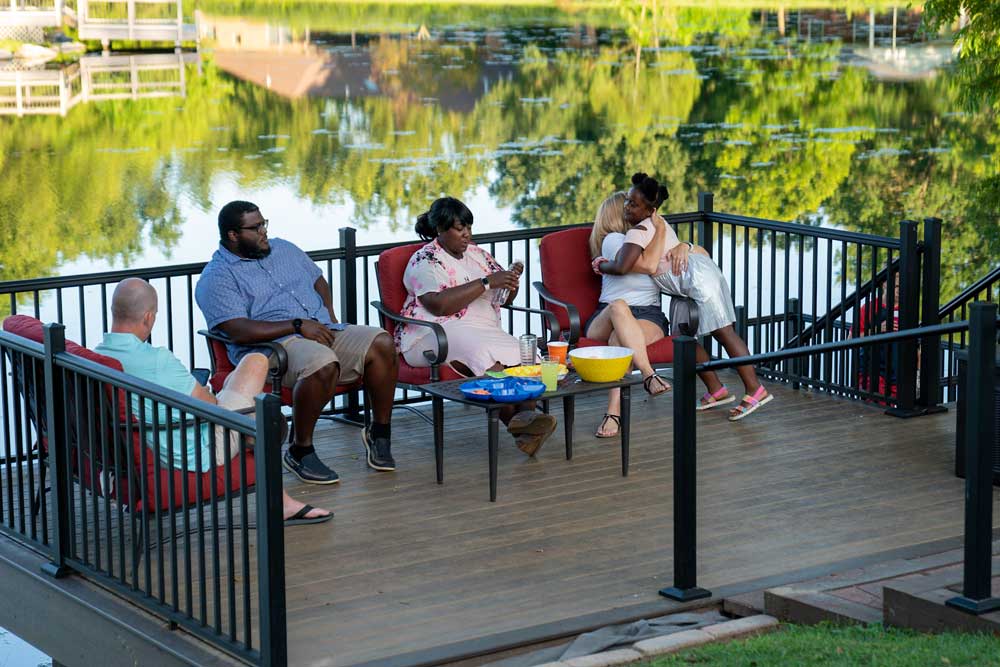 Family using deck on lake