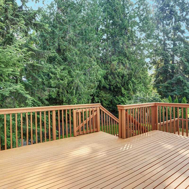 Empty walkout deck with redwood railings Large wood deck with gate