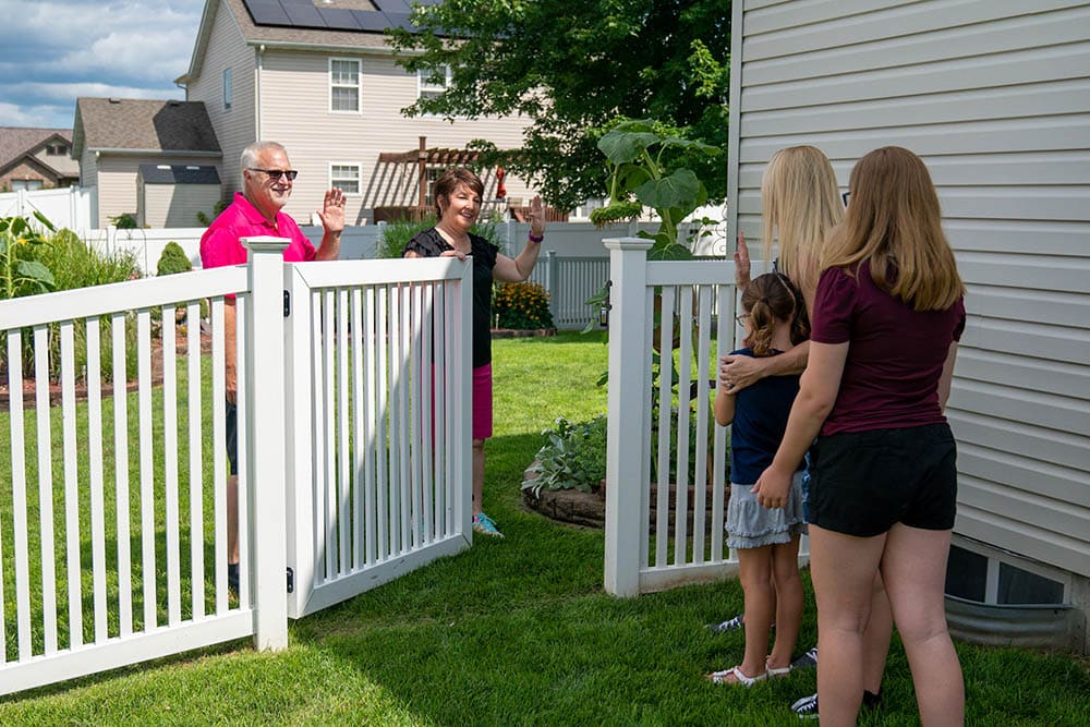 Modern vinyl fence with family opening gate