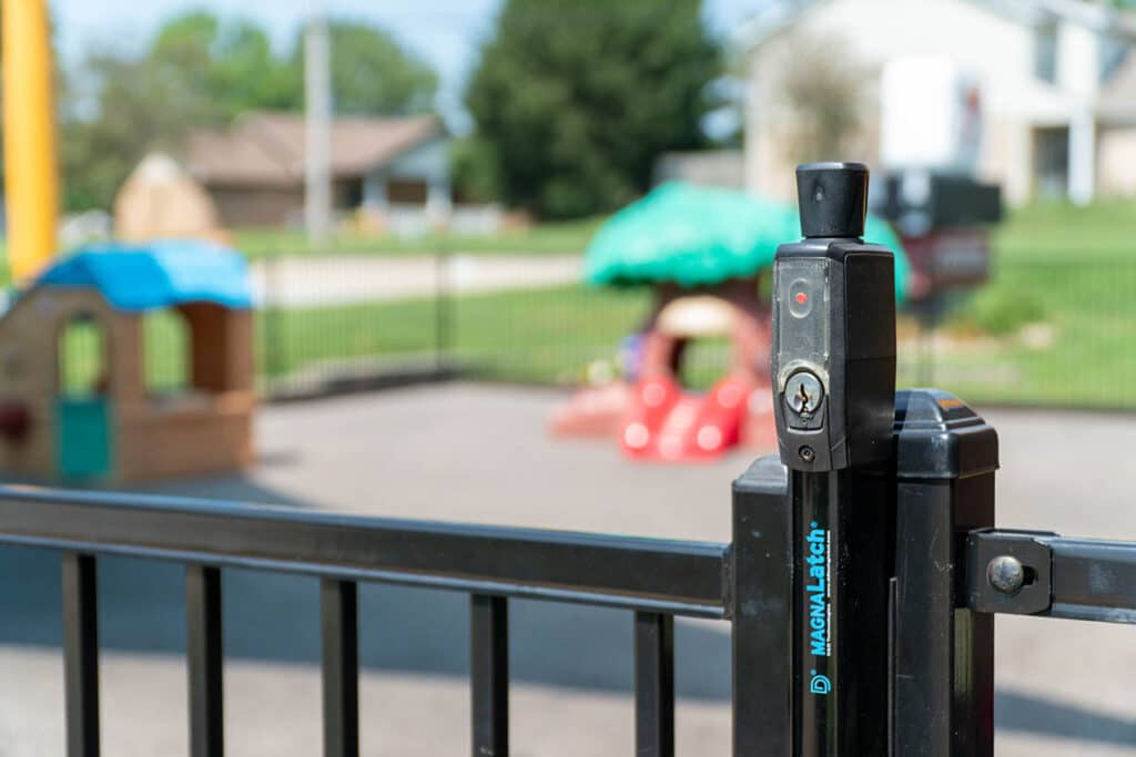 Aluminum fence with gate around playground