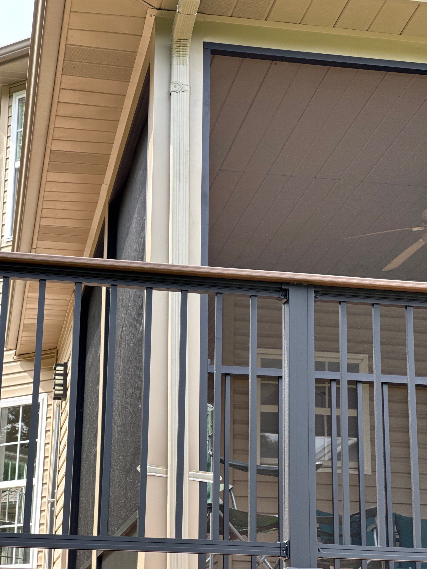Close view of new modern metal railings for the new composite deck and screened-in porch.