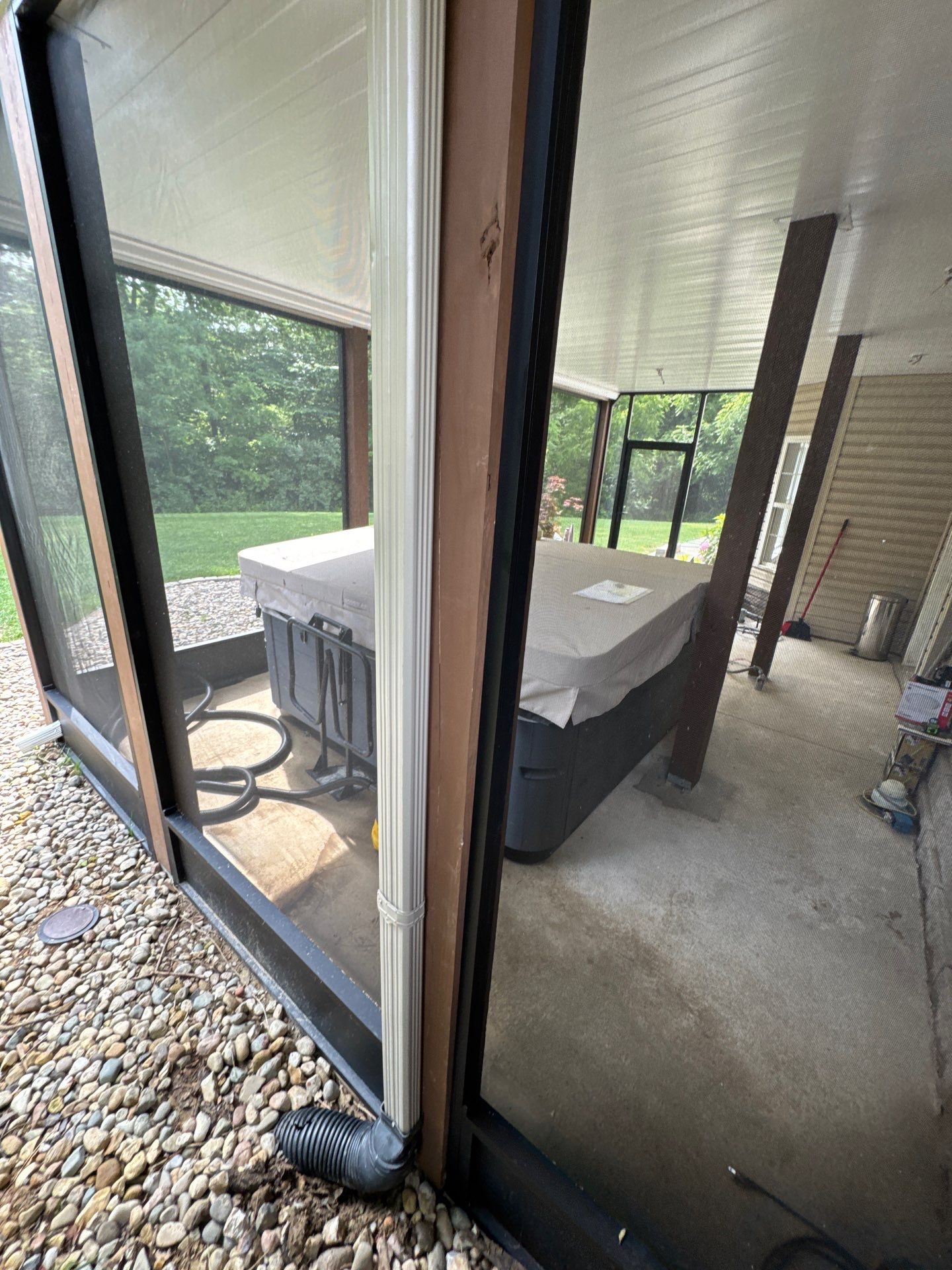 A hot tub is enclosed by a new screened-in porch