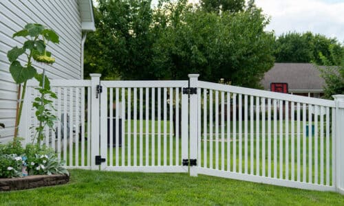 White fence with gate on hillside