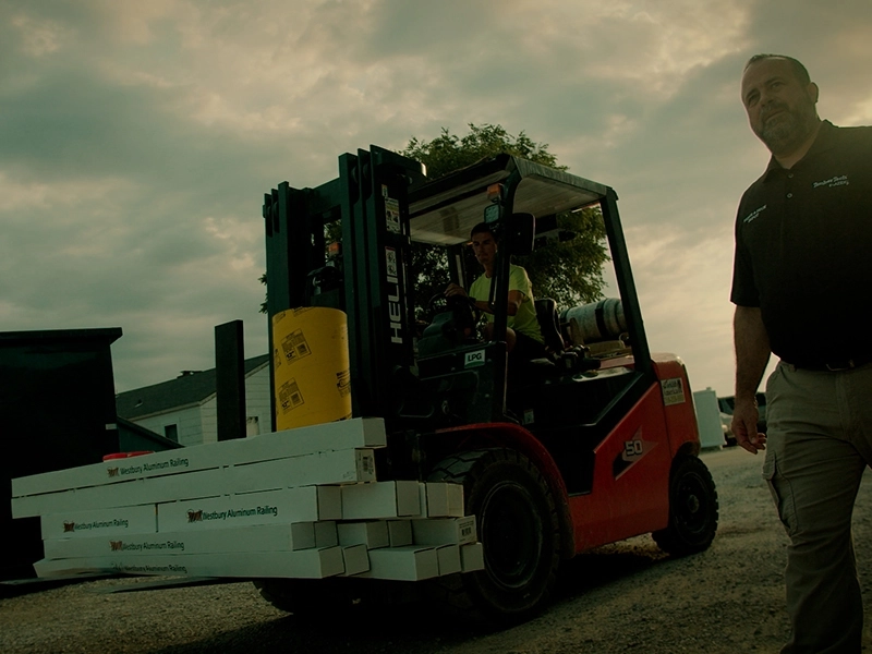 About Us Feature 1-2 Forklift and project manager walking on project site