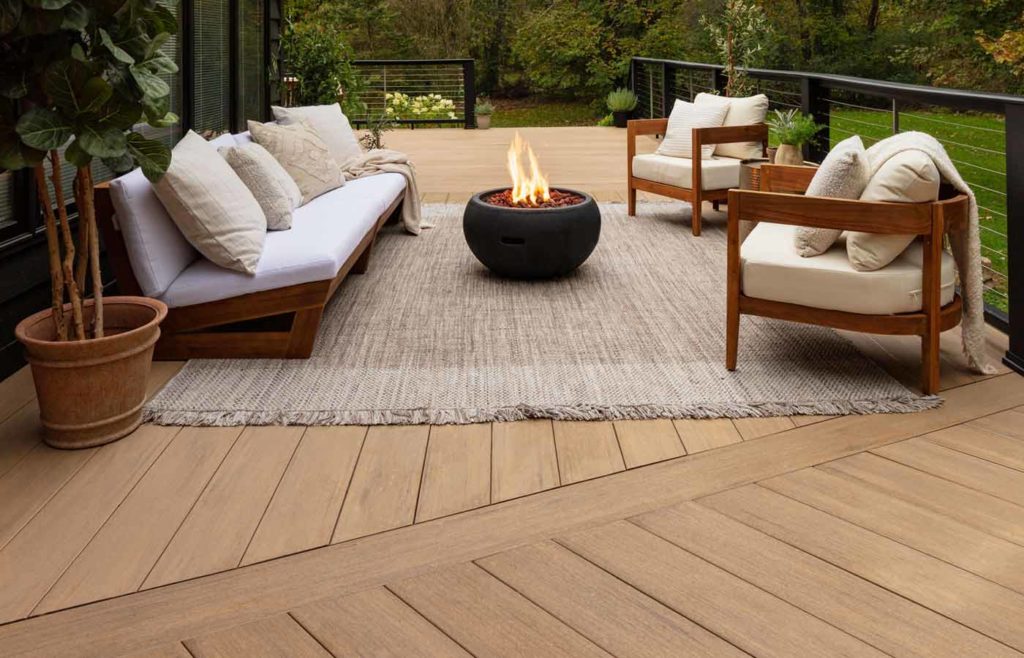 TimberTech deck with furniture and a small firepit in the center of the seating area