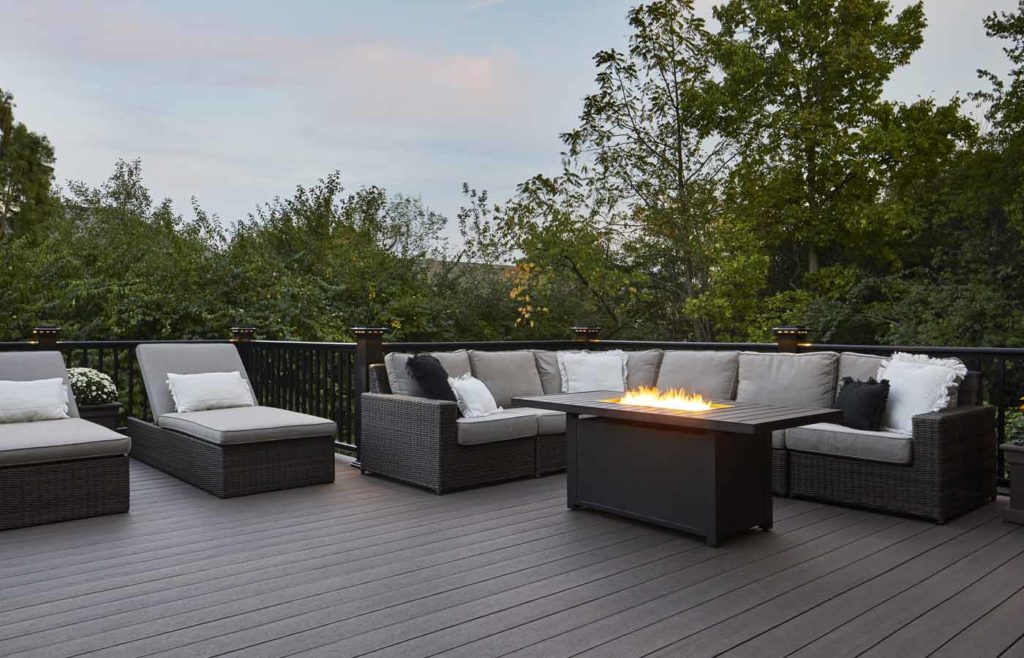 Dark gray TimberTech deck with modern furniture and fire table