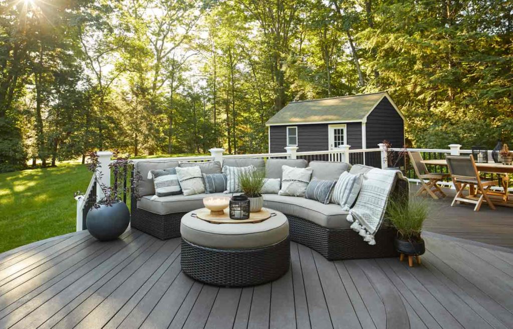 Modern gray TimberTech deck nestled in a wooded yard