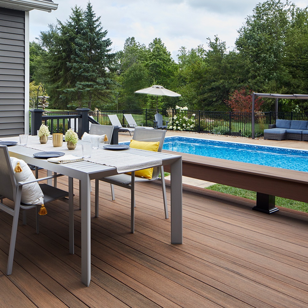 Swimming pool with surrounding deck and fence