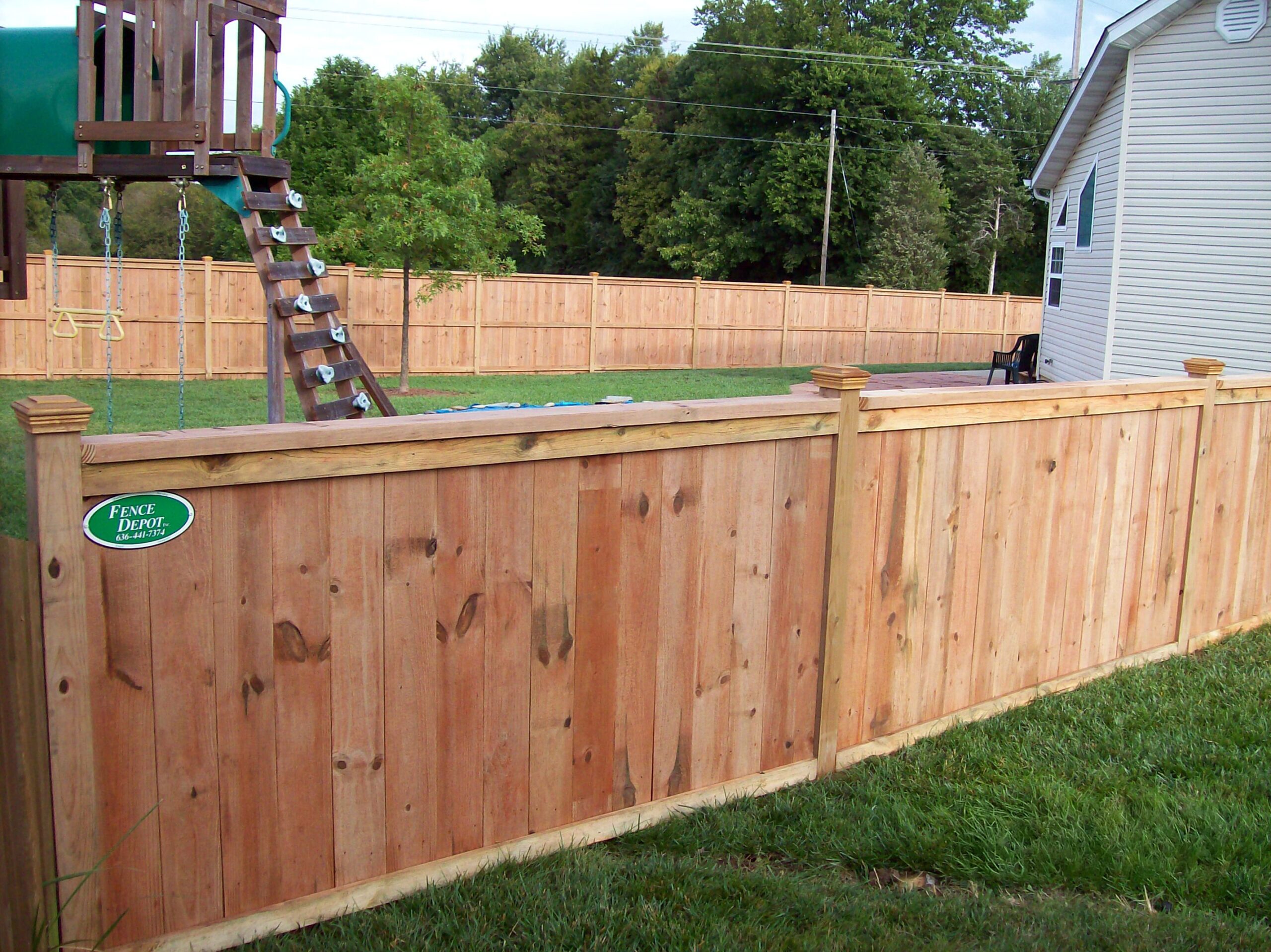 Wood privacy fence around playground
