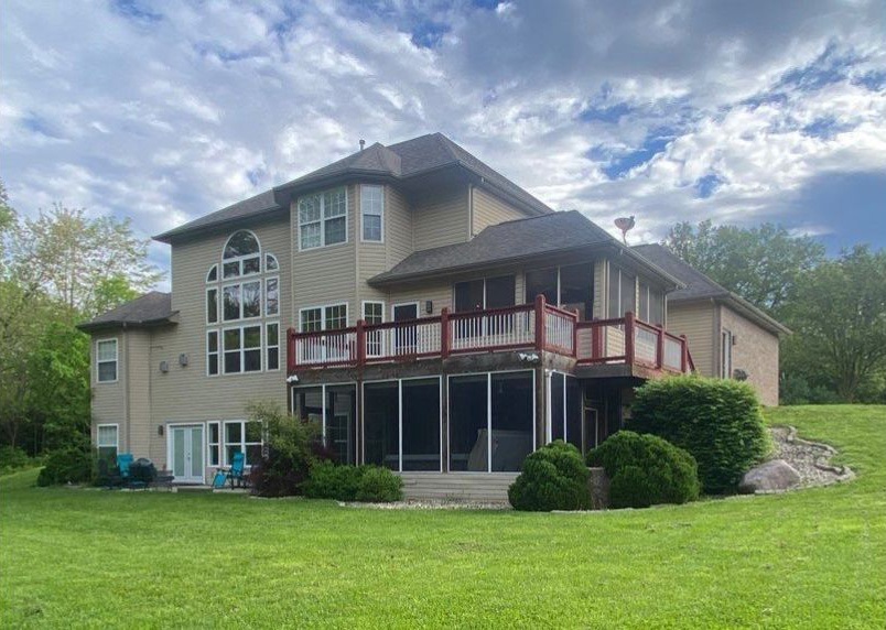 Before image of an old red wood deck and screened-in porch below the deck.