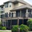 A new composite deck with a modern railing, a screened-in porch on the deck, and a screened-in underdeck system.