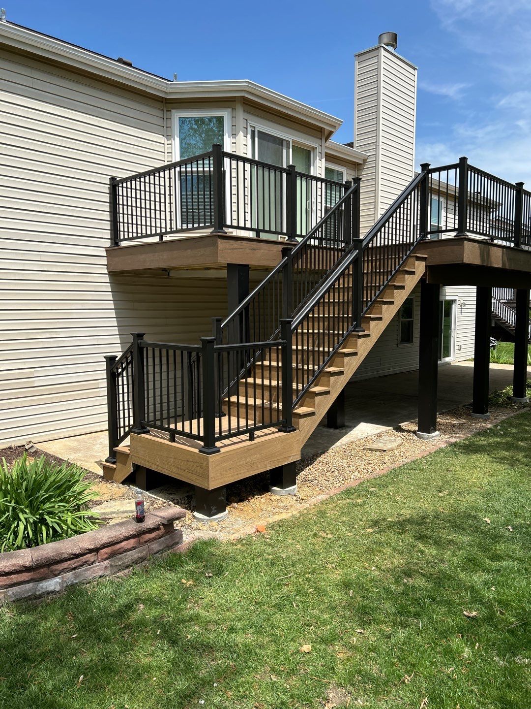 A deck with eye-catching black railings and a lighter composite decking material