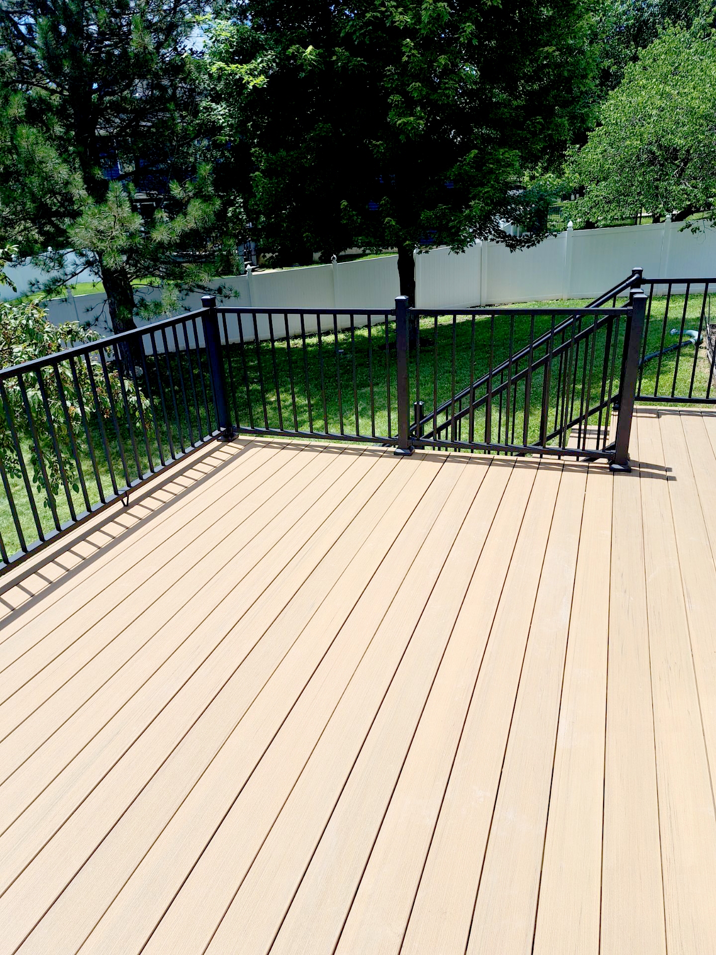 A light colored deck with black railings