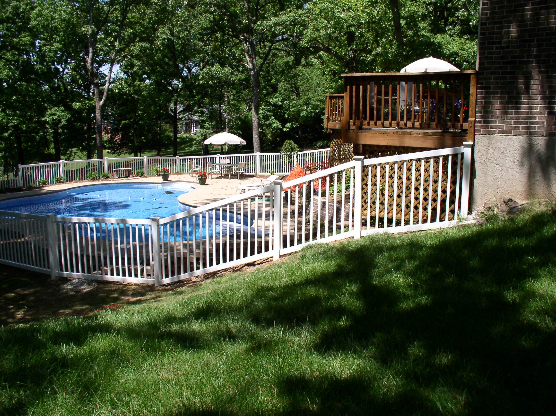 Pool area enclosed with white fence
