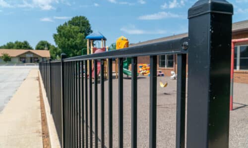 Fence-Deck-Depot-580aluminum-fence-ymca-500 Close image of an aluminum fence around playground