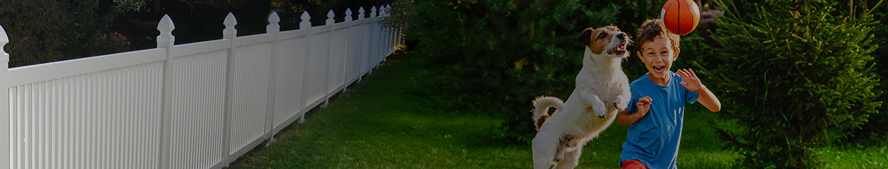 Blog header - Kid playing with dog in fenced-in yard