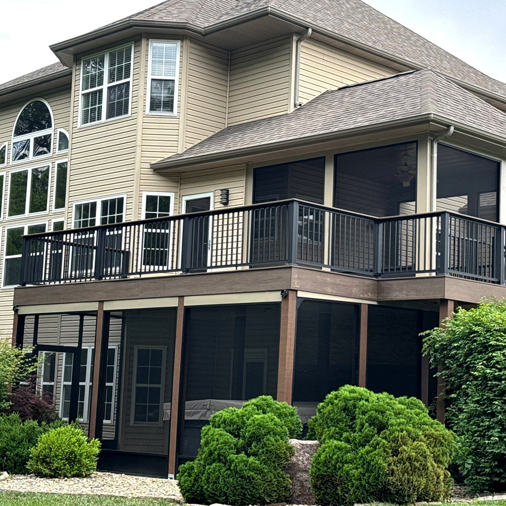 A new composite deck with a modern railing, a screened-in porch on the deck, and a screened-in underdeck system.